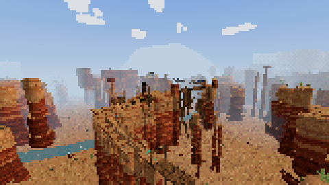 Desert canyon: red rock pillars and a rickety trestle under a blue sky.